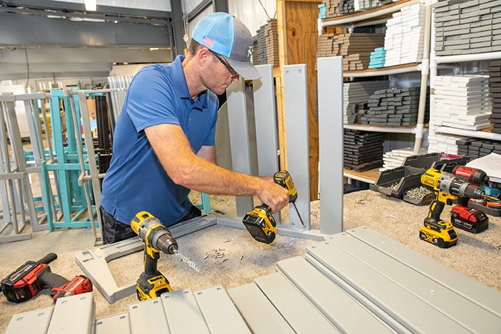 Team member assembling outdoor furniture