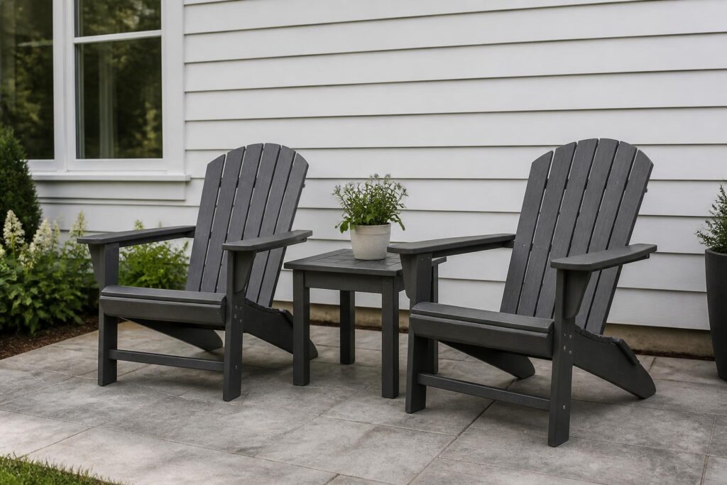 Two Adirondack chairs with an end table on a patio