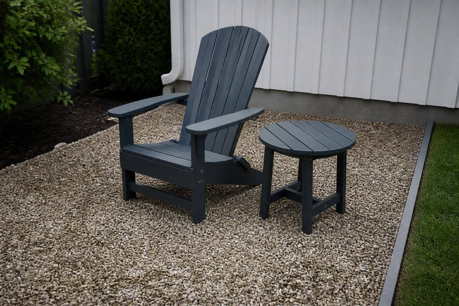 Adirondack chair and end table on contained pea gravel