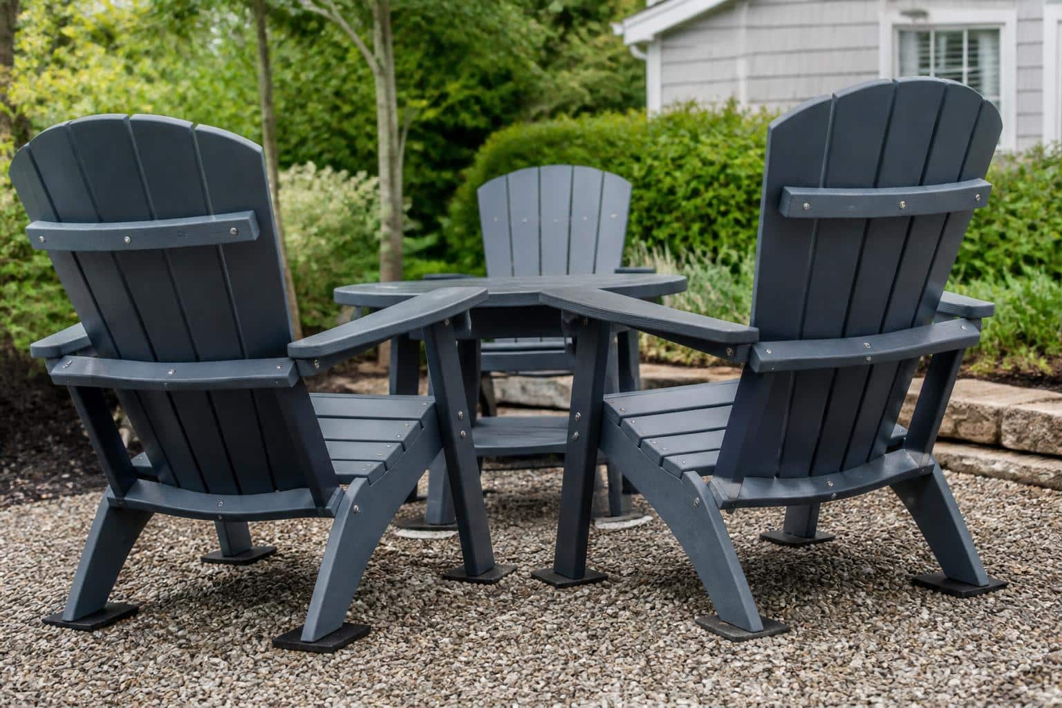 Outdoor chairs on pea gravel with a clear path